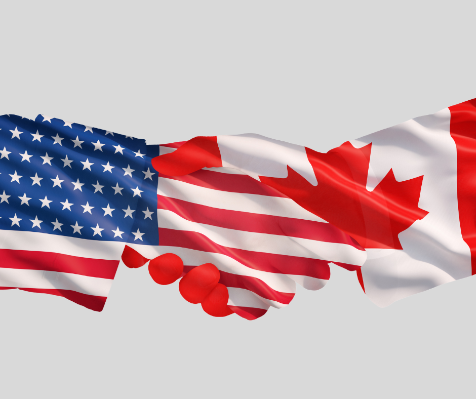 shaking hands of us and canadian flags